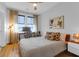 Cozy bedroom featuring a workspace, light hardwood floors, ceiling fan, and modern furnishings at 1130 5Th Ave, Charleston, SC 29407