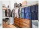 Walk-in closet with wooden dresser, shelves, and hanging rods for clothing and accessories at 1130 5Th Ave, Charleston, SC 29407