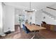 Stylish dining area featuring hardwood floors, modern lighting, and an adjacent open kitchen at 1130 5Th Ave, Charleston, SC 29407