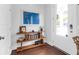 Stylish entryway featuring a modern console table with art, decor, and a view to the outdoors through the front door at 1130 5Th Ave, Charleston, SC 29407