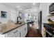Modern kitchen boasts stainless steel appliances, granite countertops, and seamless flow into the living area for open concept living at 1130 5Th Ave, Charleston, SC 29407