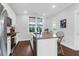 Modern kitchen with island, granite countertops, stainless steel appliances, and wood flooring at 1130 5Th Ave, Charleston, SC 29407