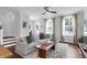 Inviting living room featuring hardwood floors, a plush sectional and lots of natural light at 1130 5Th Ave, Charleston, SC 29407
