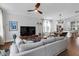 Bright living room featuring hardwood floors and a gray sectional with an open floor plan at 1130 5Th Ave, Charleston, SC 29407