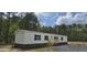 Charming single-story home with white siding, black shutters, and a stone foundation at 115 Sandy Oaks Ln, Cross, SC 29436