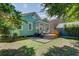 Well-maintained backyard featuring a wooden deck, lush lawn, and charming string lights for outdoor gatherings at 1157 King St, Charleston, SC 29403