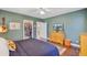 Spacious bedroom boasts hardwood floors, a decorative rug, TV, and access to a walk-in closet at 1157 King St, Charleston, SC 29403