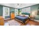 Well-lit bedroom featuring a large bed, hardwood floors, and an ample amount of natural light at 1157 King St, Charleston, SC 29403