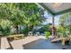 Inviting outdoor space with wooden deck, seating, lush greenery, and string lights creating a serene atmosphere at 1157 King St, Charleston, SC 29403