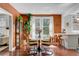 A cozy dining area boasts an elegant marble table, warm lighting, and inviting decor at 1157 King St, Charleston, SC 29403