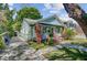 Inviting home featuring a well-manicured lawn, quaint porch, and private driveway at 1157 King St, Charleston, SC 29403