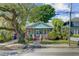 Charming home with lush trees, inviting porch, and classic curb appeal at 1157 King St, Charleston, SC 29403