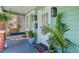 Inviting front porch with hanging swing, potted plants, and craftsman details at 1157 King St, Charleston, SC 29403