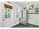 Bright and clean kitchen area with stainless steel refrigerator and access to the backyard at 1157 King St, Charleston, SC 29403