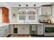 A clean and bright kitchen area featuring modern gray cabinets and a stainless steel oven at 1157 King St, Charleston, SC 29403