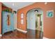 Stylish living area with hardwood floors, arched doorway, and a charming distressed blue armoire cabinet at 1157 King St, Charleston, SC 29403