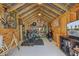 Spacious shed interior with fitness equipment, storage, and a TV setup for a versatile workout space at 1157 King St, Charleston, SC 29403