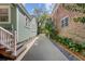 Side yard view showcasing the property's well-manicured landscape, charming details, and curb appeal at 1157 King St, Charleston, SC 29403