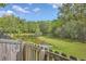 Backyard view from behind the wood fence overlooking the pond, the pine and deciduous trees at 120 Indigo Marsh Cir, Wando, SC 29492