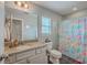 Bright bathroom featuring granite counters, white cabinetry, and a colorful shower curtain at 120 Indigo Marsh Cir, Wando, SC 29492