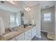 Bathroom featuring double sinks with granite countertops and framed mirror at 120 Indigo Marsh Cir, Wando, SC 29492