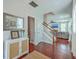 Inviting entryway featuring wood floors, stairs, and a glimpse into the spacious living room at 120 Indigo Marsh Cir, Wando, SC 29492