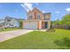 Charming two-story home featuring a two-car garage, manicured lawn, and inviting curb appeal at 120 Indigo Marsh Cir, Wando, SC 29492