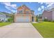 Charming two-story home featuring a two-car garage, manicured lawn, and inviting curb appeal at 120 Indigo Marsh Cir, Wando, SC 29492