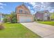 Charming two-story home featuring a two-car garage, manicured lawn, and inviting curb appeal at 120 Indigo Marsh Cir, Wando, SC 29492
