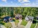 Overhead view of three well-maintained homes with manicured lawns and mature trees at 123 Dasharon Ln, Goose Creek, SC 29445