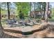 Serene backyard with a charming stone fire pit and Adirondack chairs, perfect for outdoor gatherings at 123 Dasharon Ln, Goose Creek, SC 29445