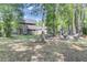 Scenic backyard view with lush greenery, mature trees, and an outdoor seating area at 123 Dasharon Ln, Goose Creek, SC 29445