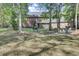 Expansive backyard featuring mature trees, a seating area, and a screened porch, ideal for relaxation and outdoor activities at 123 Dasharon Ln, Goose Creek, SC 29445