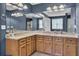 Well-lit bathroom with double sinks, beautiful cabinets, and a large mirror over the vanity area at 123 Dasharon Ln, Goose Creek, SC 29445