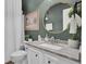 Cozy bathroom with a white vanity, oval mirror, and decorative accents at 123 Dasharon Ln, Goose Creek, SC 29445