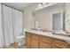 Well-lit bathroom features a wood vanity, marble countertop, shower with curtain and tile floors at 123 Dasharon Ln, Goose Creek, SC 29445