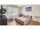 Bright bedroom featuring hardwood floors, a ceiling fan, and a large window with natural light at 123 Dasharon Ln, Goose Creek, SC 29445