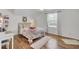 Sunlit bedroom showcasing wood floors, light walls, a window, and a cozy rug at 123 Dasharon Ln, Goose Creek, SC 29445