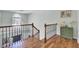 Bright foyer features hardwood floors, staircase with iron railing, and a decorative chandelier over the front door at 123 Dasharon Ln, Goose Creek, SC 29445