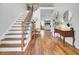 Spacious foyer with staircase, hardwood floors, and bright light from the entry at 123 Dasharon Ln, Goose Creek, SC 29445