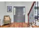 Inviting foyer features hardwood floors, staircase, and a charming sitting area at 123 Dasharon Ln, Goose Creek, SC 29445