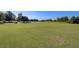 Beautiful golf course with lush green grass, mature trees, and riding lawn mower at 123 Dasharon Ln, Goose Creek, SC 29445