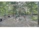 Community playground with swings, slide, climbing structure, and wood chip ground cover surrounded by mature trees at 123 Dasharon Ln, Goose Creek, SC 29445
