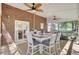 Inviting screened porch with brick accents, ceiling fans, and comfortable outdoor seating. Includes a dining table, and living space at 123 Dasharon Ln, Goose Creek, SC 29445