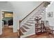 Staircase with wood treads, iron spindles, and a small table and chair at 123 Dasharon Ln, Goose Creek, SC 29445