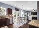 Bright dining space adjacent to the kitchen, featuring dark cabinets and stainless steel appliances at 1255 Horseshoe Bnd, Mount Pleasant, SC 29464