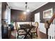 View of a well-lit dining room featuring a wooden table with four chairs and decorative lighting at 1255 Horseshoe Bnd, Mount Pleasant, SC 29464