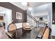 Dining room showcases dark wood table with seating, connecting to a staircase and adjacent kitchen at 1255 Horseshoe Bnd, Mount Pleasant, SC 29464