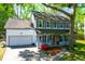 Inviting two-story house with a cozy front porch, bright red door, and attached garage at 1255 Horseshoe Bnd, Mount Pleasant, SC 29464