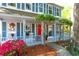 Charming front porch with rocking chairs, vibrant azaleas, and a bright red front door at 1255 Horseshoe Bnd, Mount Pleasant, SC 29464